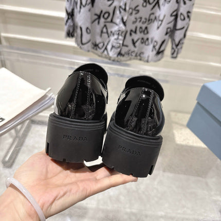 PRADA 26S PLATFORM LOAFERS 45MM IN BLACK PATENT CALFSKIN
