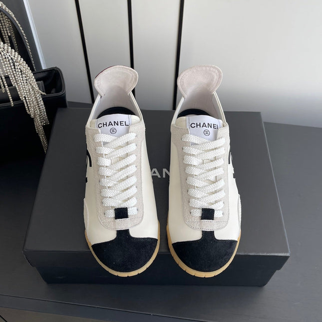 CHANEL LOW-TOP SNEAKERS IN BLACK AND WHITE CALFSKIN MIX SUEDE