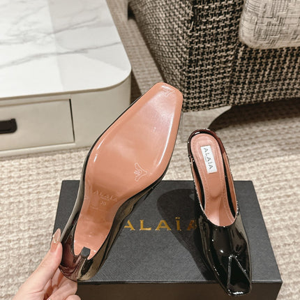 ALAIA SPIKE JEWEL MULES IN BLACK GLOSSY CALFSKIN