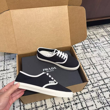 PRADA 26S LACE UP SNEAKERS IN BLACK AND WHITE CANVAS