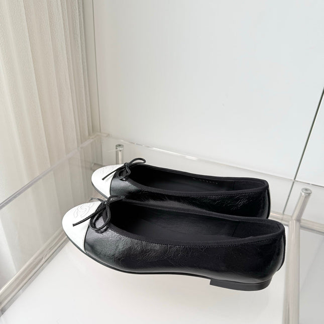 CHANEL 26S BALLET FLATS IN BLACK CRACKED CALFSKIN WITH WHITE TOE CAP AND BOW