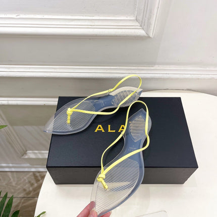 ALAIA 26S POINTED-TOE THONG SANDALS IN YELLOW AND TRANSPARENT PVC