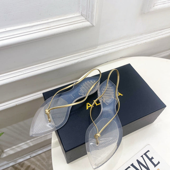 ALAIA 26S POINTED-TOE THONG SANDALS IN GOLD AND TRANSPARENT PVC