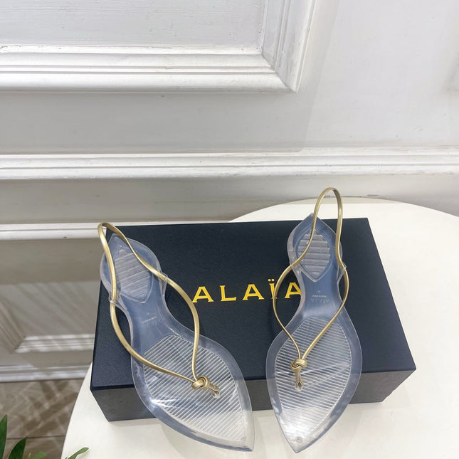 ALAIA 26S POINTED-TOE THONG SANDALS IN GOLD AND TRANSPARENT PVC