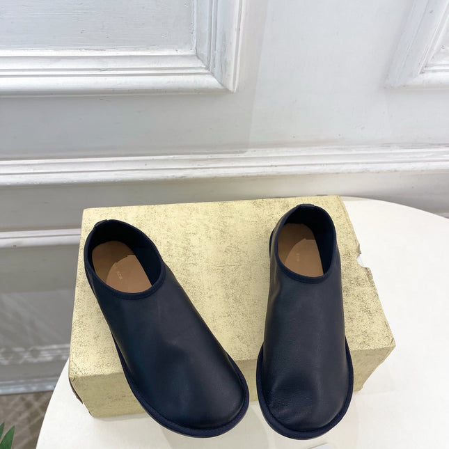 THE ROW 26S SLIP-ON FLATS IN BLACK NAPPA CALFSKIN