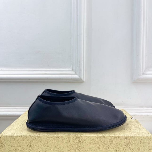 THE ROW 26S SLIP-ON FLATS IN BLACK NAPPA CALFSKIN
