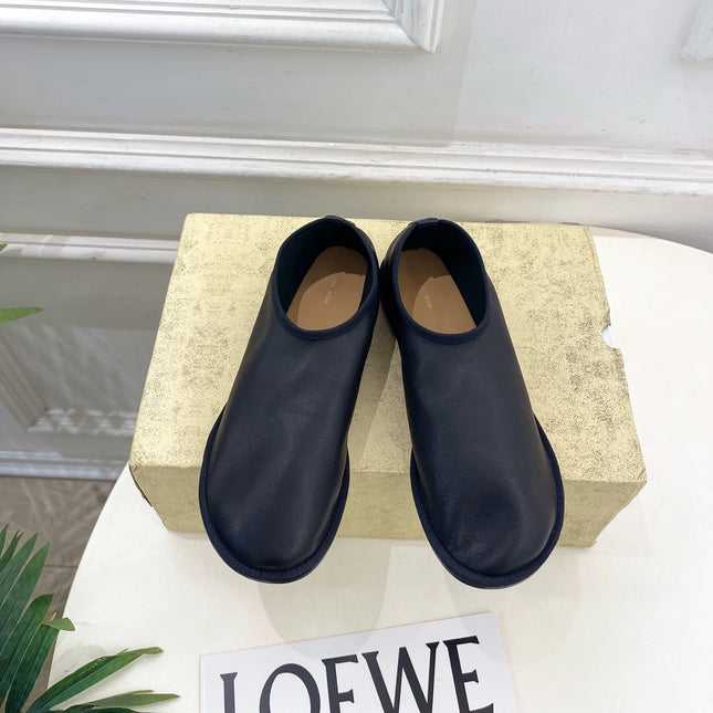 THE ROW 26S SLIP-ON FLATS IN BLACK NAPPA CALFSKIN