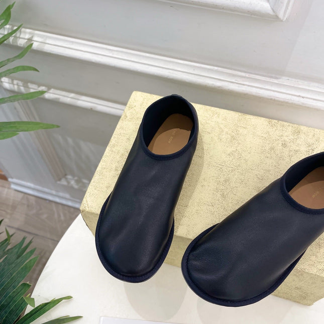 THE ROW 26S SLIP-ON FLATS IN BLACK NAPPA CALFSKIN